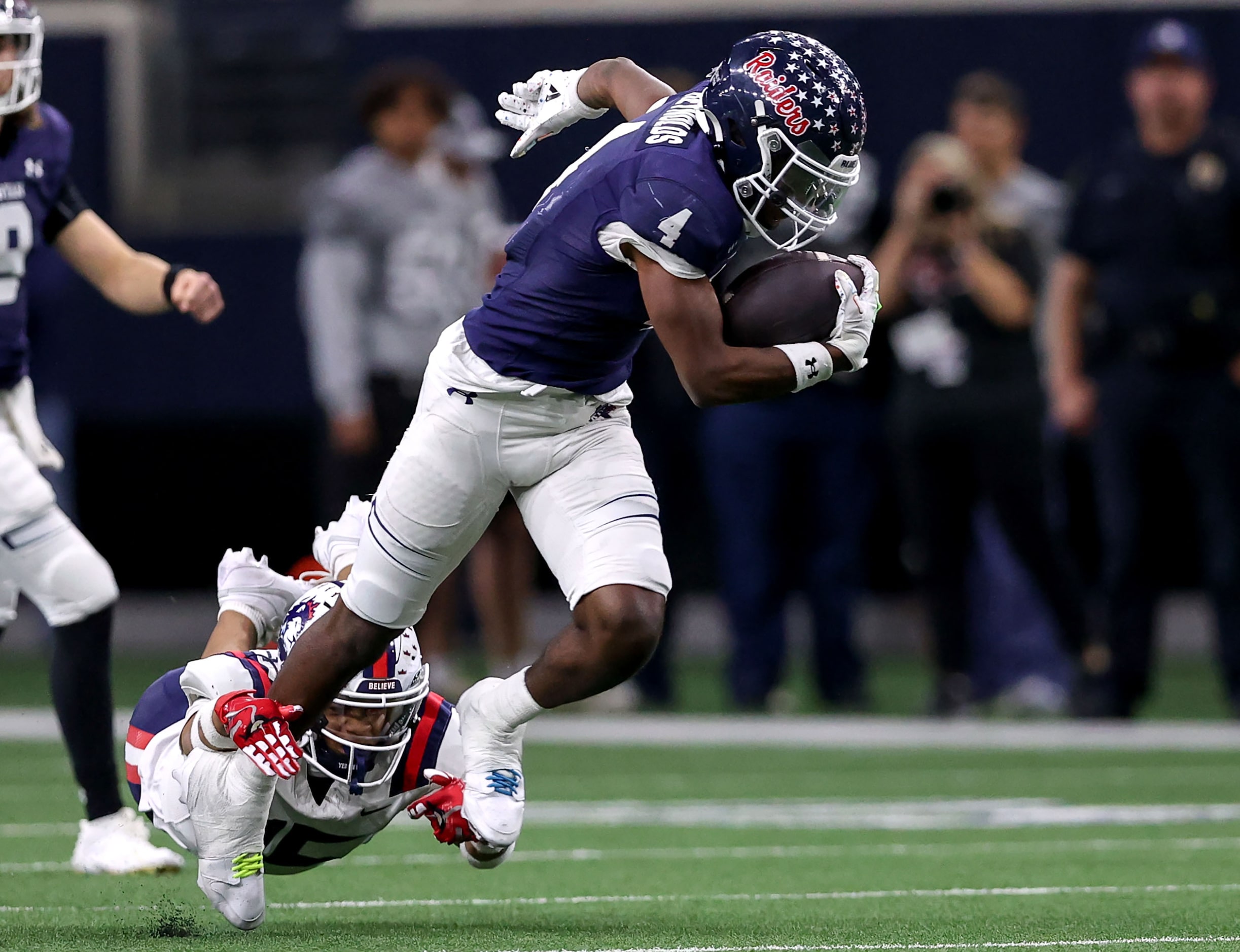 Denton Ryan running back Tre'Vaughn Reynolds (4) breaks free from Richland defensive back...