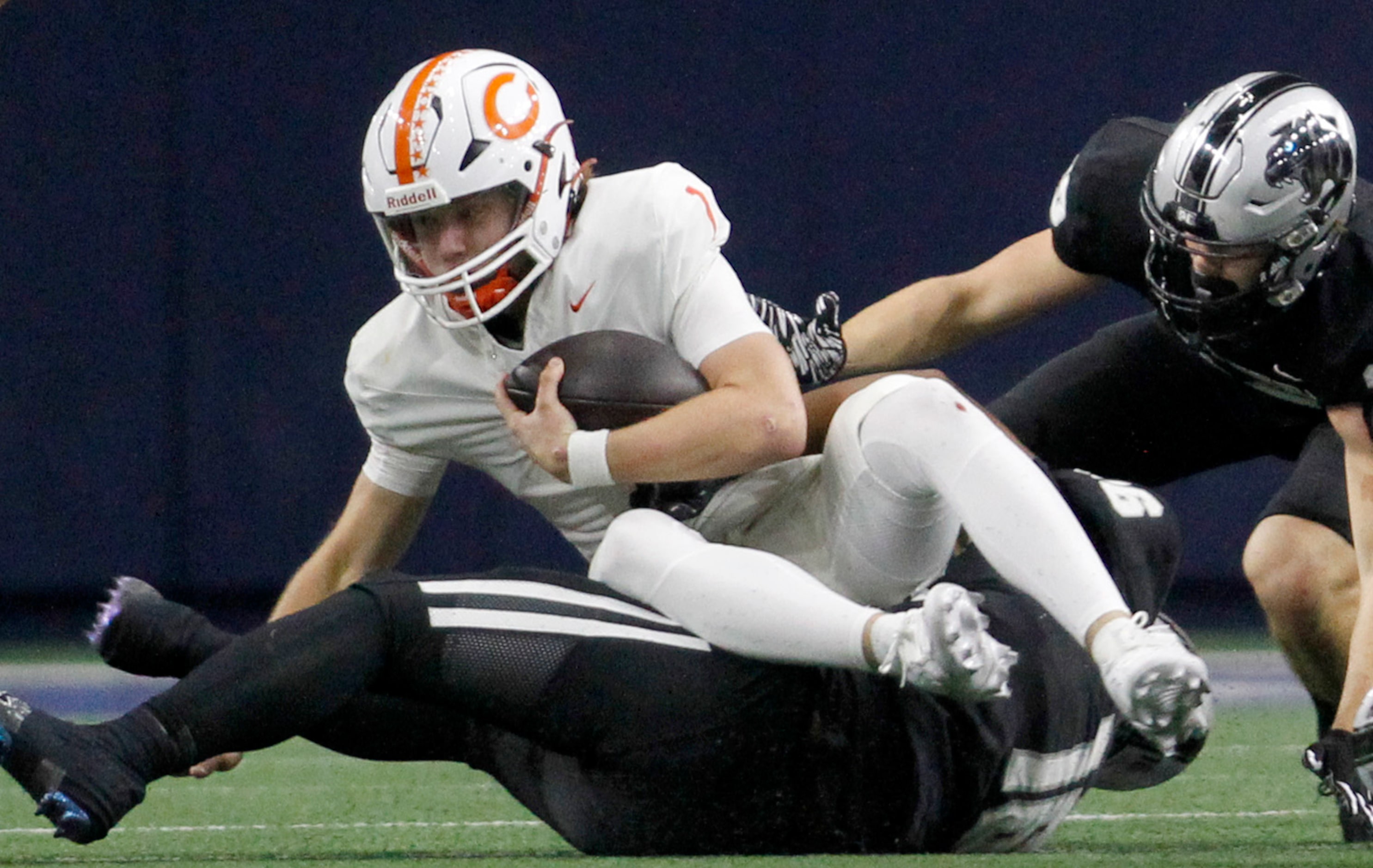 Celina quarterback Bowe Bentley (1) is stopped by Frisco panther Creek defensive lineman...