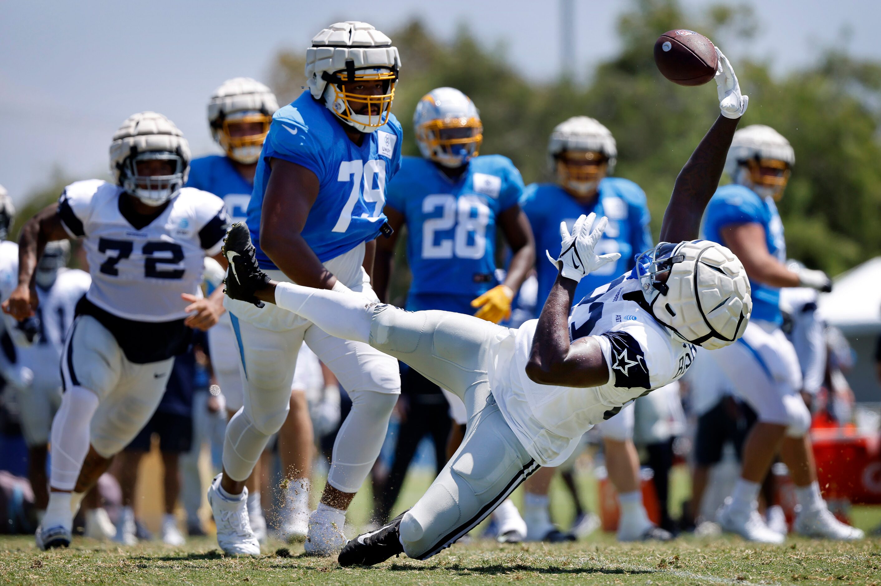 Dallas Cowboys defensive end Tarell Basham (93) makes an interception as he was falling the...