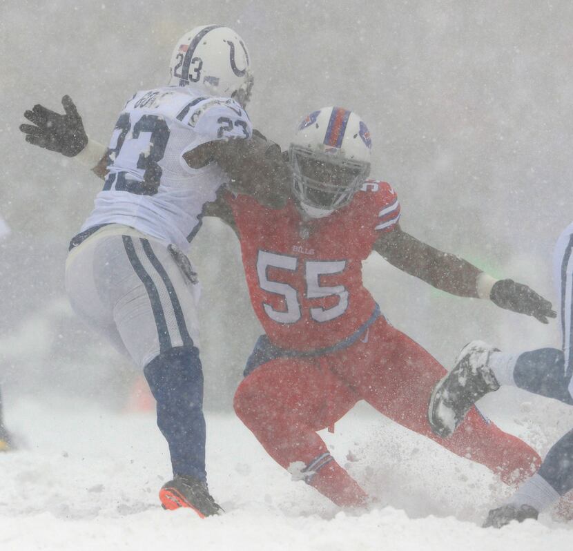 Buffalo Bills defensive end Jerry Hughes, right, tries to tackle Indianapolis Colts running...
