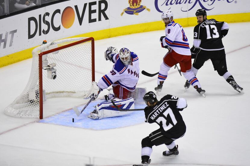 Los Angeles Kings defender Alec Martinez (27) scores the winning goal in double overtime...
