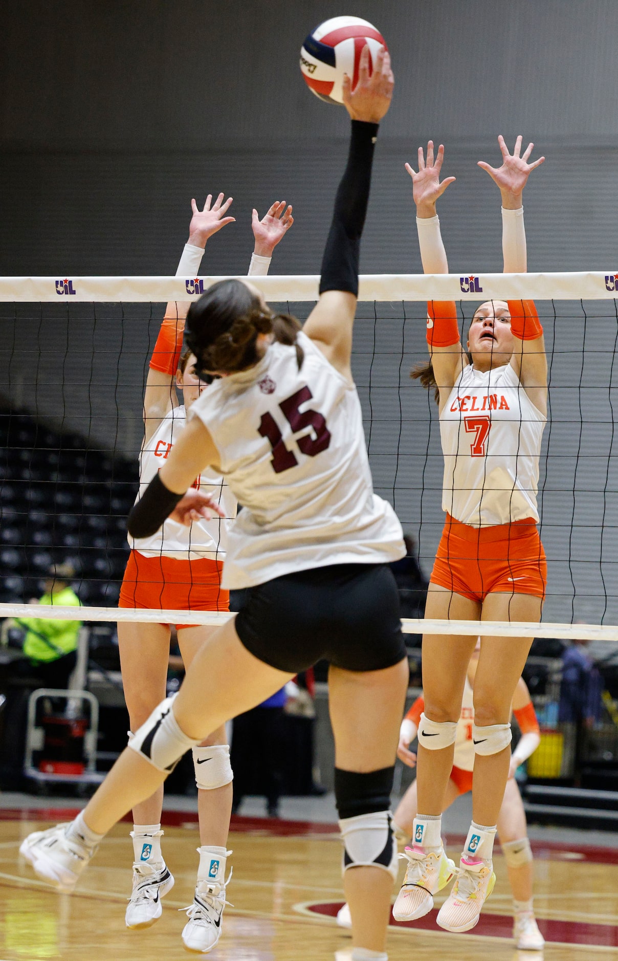 Celina's Ryan McCoy (7) tries to block a spike by Comal Davenport's Ashtan Dodson (15)...