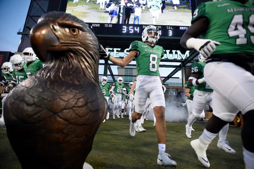 North Texas sophomore wide receiver Rico Bussey, Jr. (8) touches the eagle statue as he...
