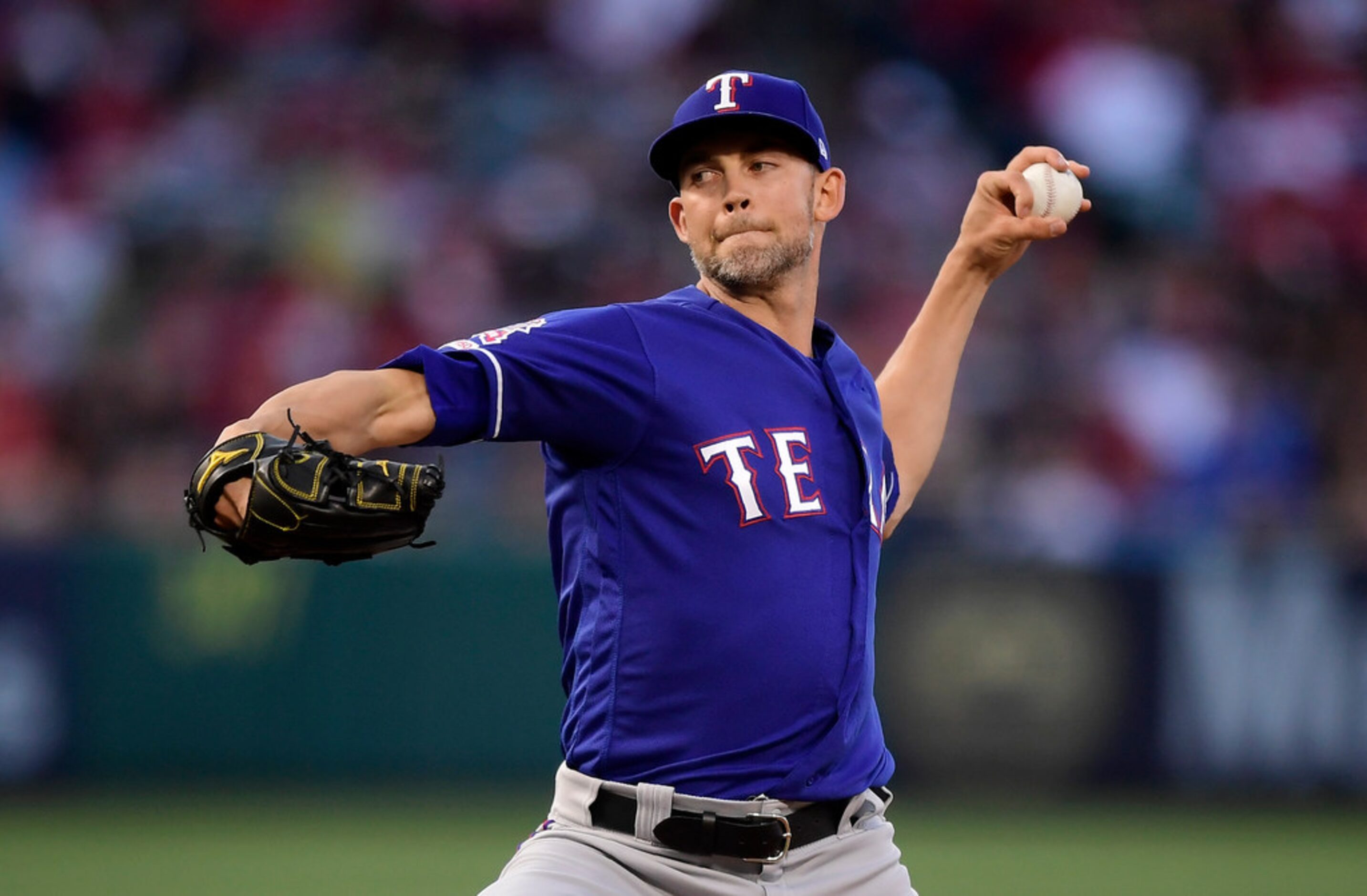 Texas Rangers starting pitcher Mike Minor throws during the first inning of the team's...