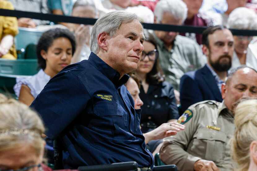 Gov. Greg Abbott listens to a local pastor during a vigil for victims of the Robb Elementary...