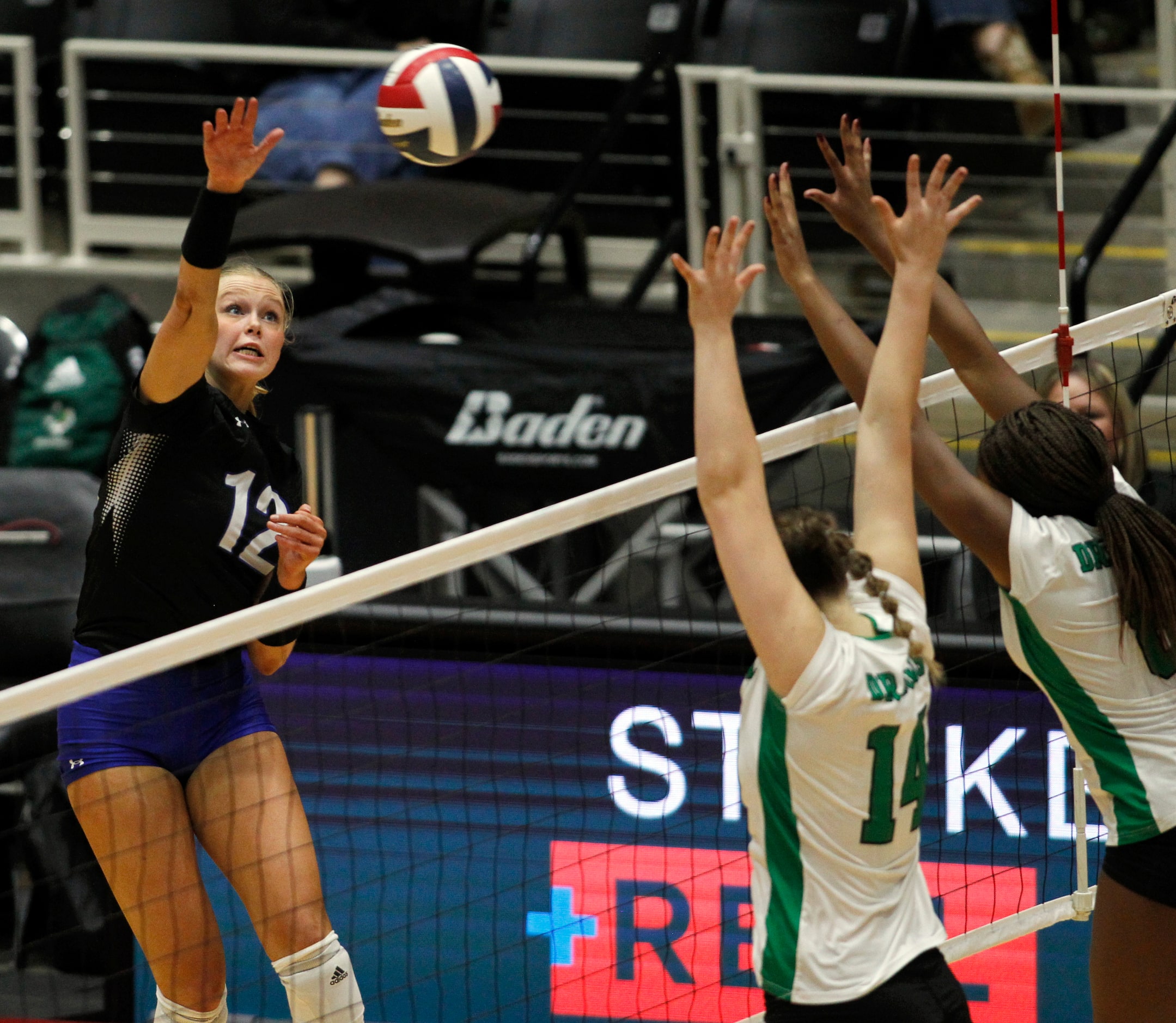 Byron Nelson outside hitter Ashlyn Seay (12), left, fires a shot against the defense of...