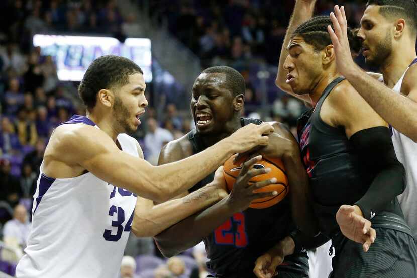 TCU Horned Frogs guard Kenrich Williams (34) and Southern Methodist Mustangs forward Akoy...