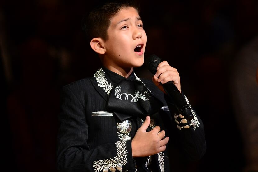 Sebastien De La Cruz, known as San Antonios Little Mariachi, sings the national anthem prior...