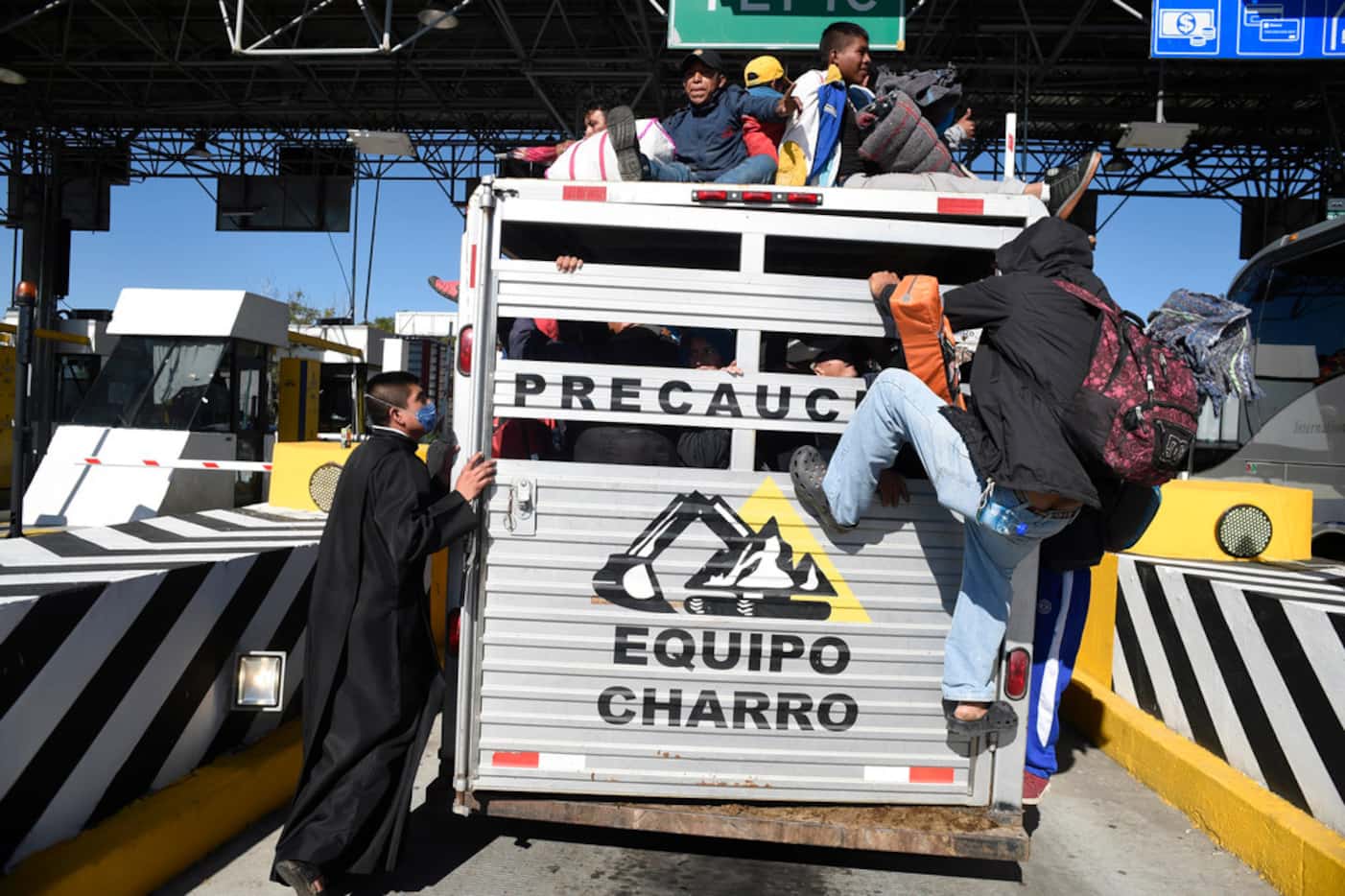 Central American migrants climbed aboard a truck on the road between Zapopan and Tequila, in...