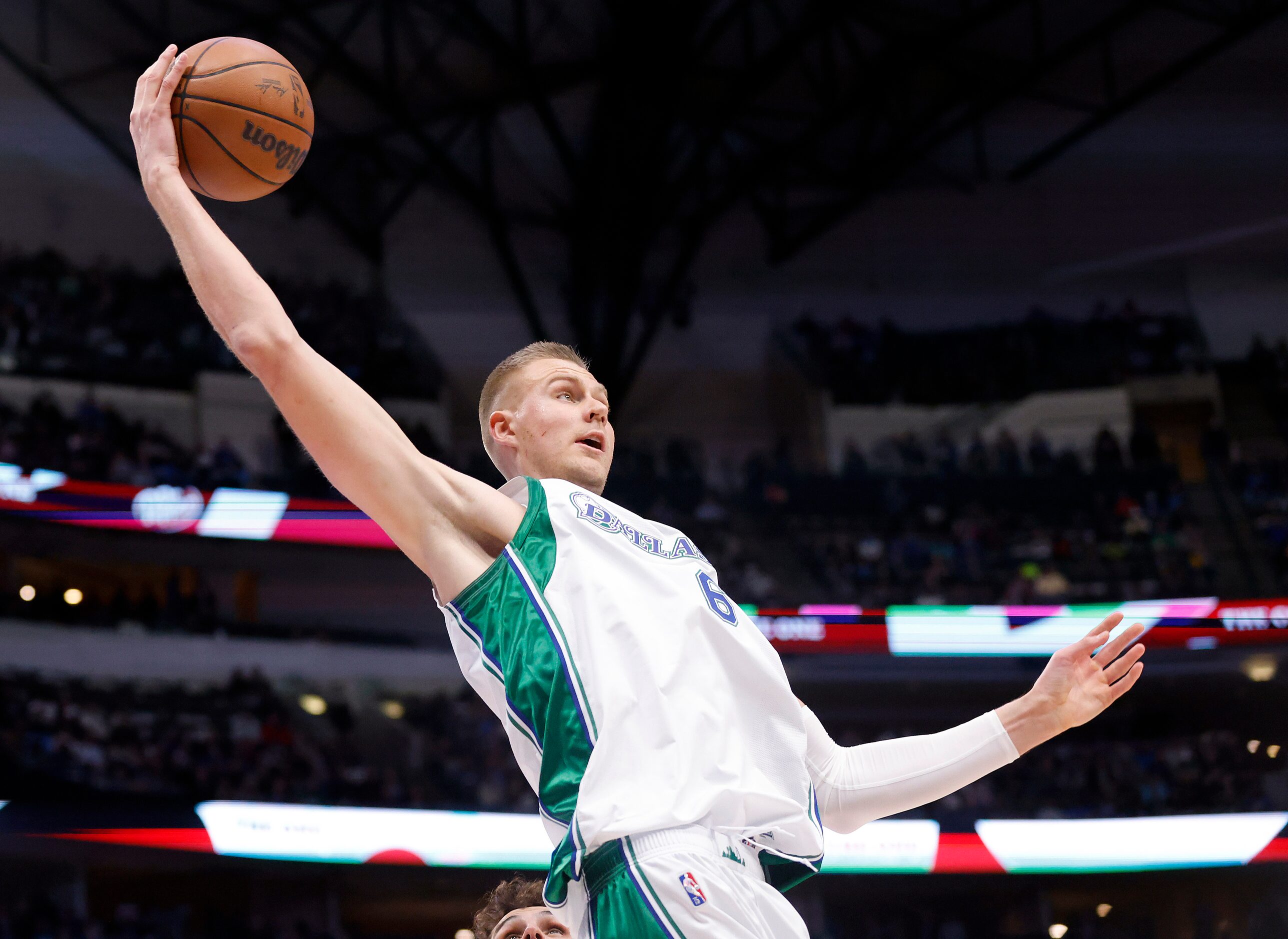 Dallas Mavericks center Kristaps Porzingis (6) goes high for an offensive rebound against...