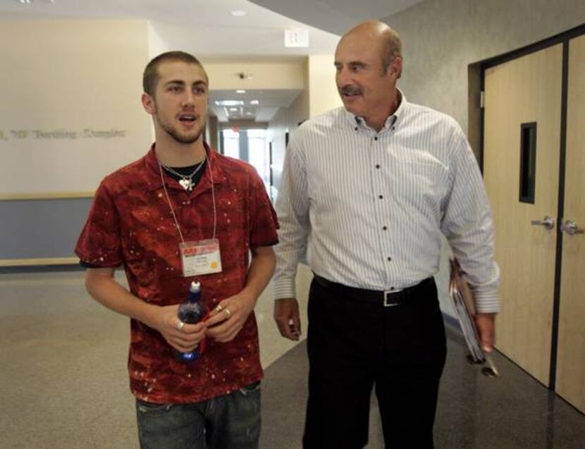 Phil McGraw, TV's Dr. Phil, and son Jordan walk the halls of the Junkins Building at SMU...