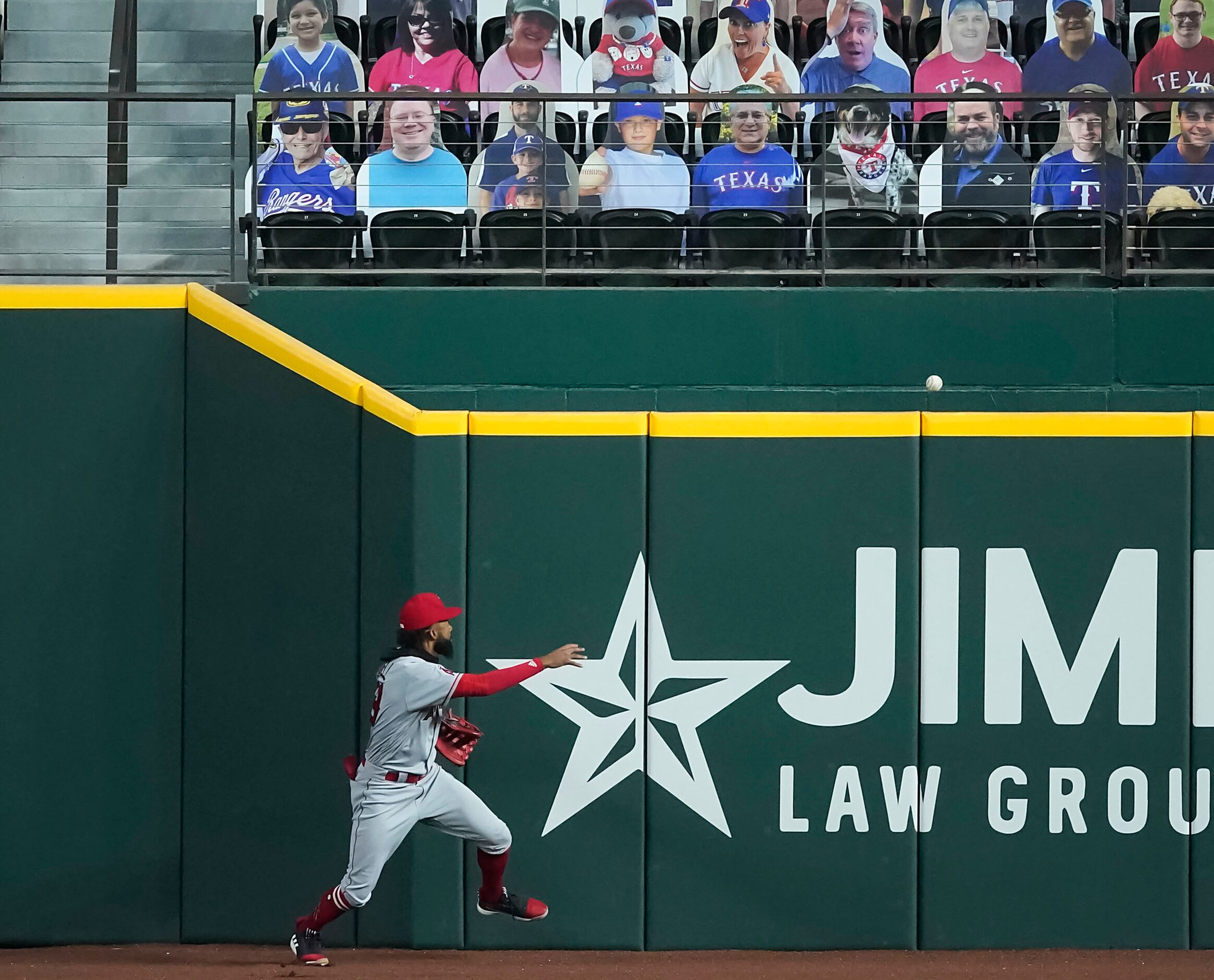 SEQUENCE THREE-OF-FOUR: Los Angeles Angels right fielder Jo Adell has the ball go off his...