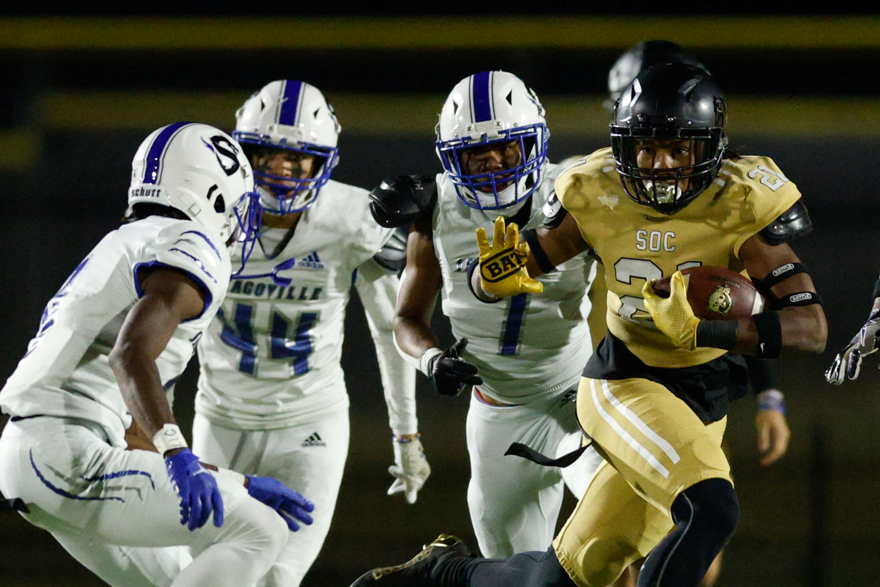 South Oak Cliff running back Danny Green (21) looks to stiff-arm Seagoville defensive back...