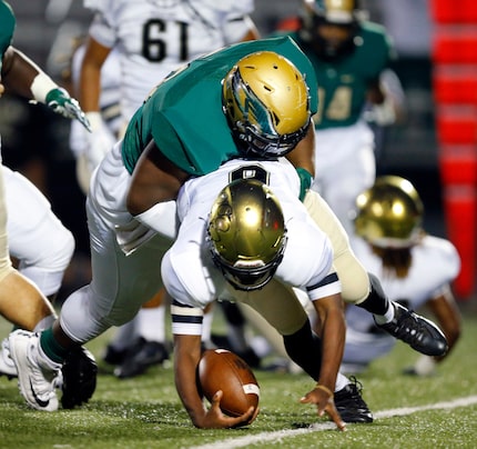 DeSoto defensive lineman Wesley Green (56) sacks Irving quarterback Levante Briggs (6) in...