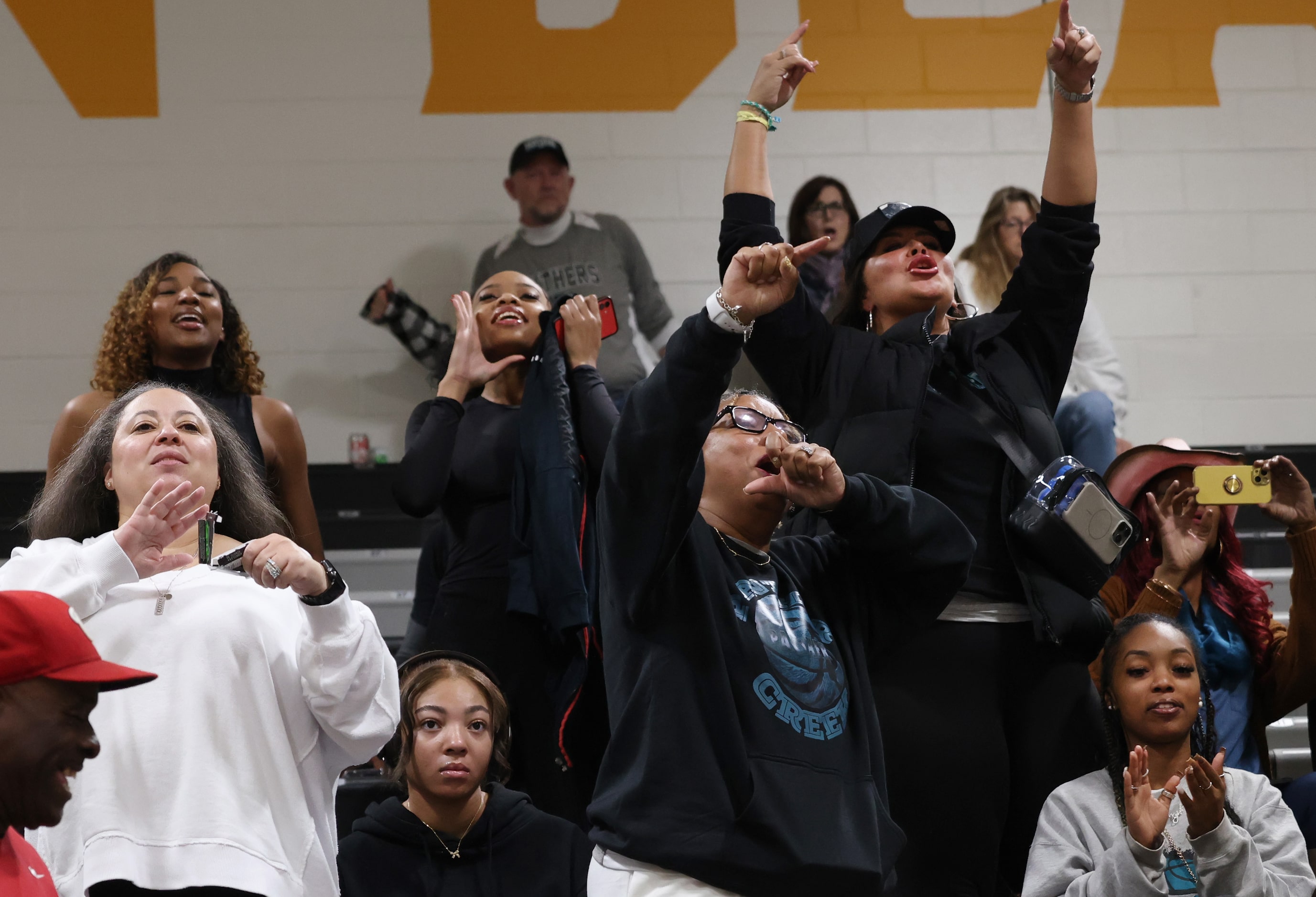 A group of Frisco Panther Creek fans erupt following the final buzzer of the team's 61-55...