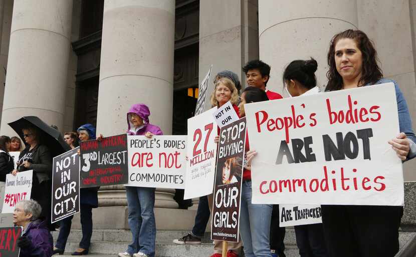 People opposed to child sex trafficking rally outside of the Washington state Supreme Court...