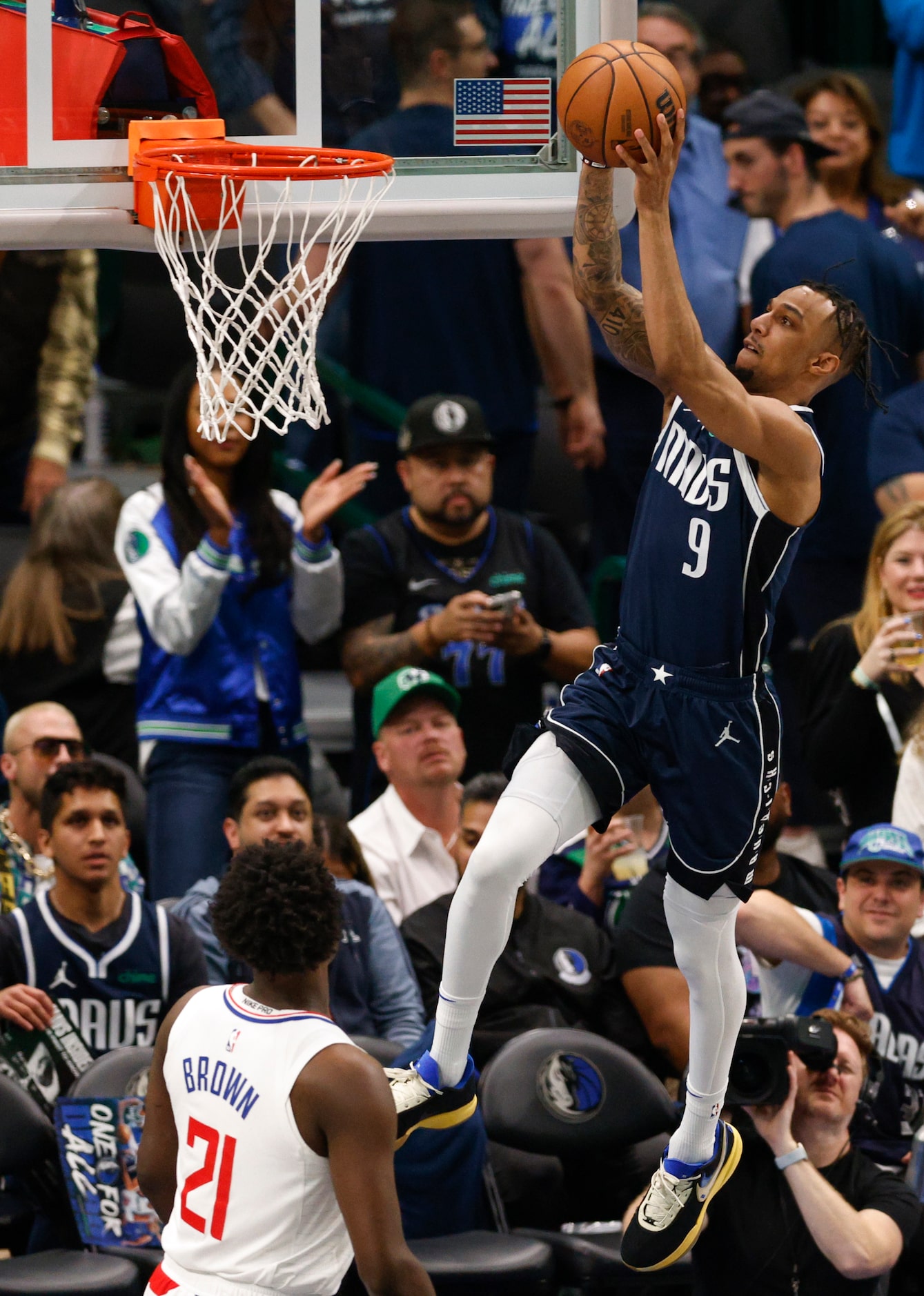 Dallas Mavericks guard A.J. Lawson (9) dunks the ball over LA Clippers guard Kobe Brown (21)...