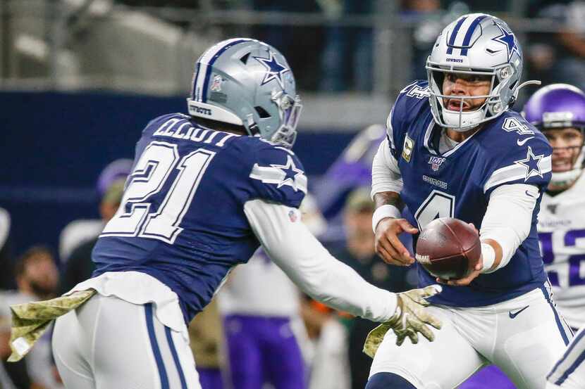 Dallas Cowboys quarterback Dak Prescott (4) hands off to running back Ezekiel Elliott (21)...