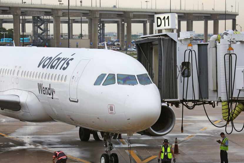 A Volaris plane pulls into Terminal D at DFW Airport, photographed on Monday, August 22,...