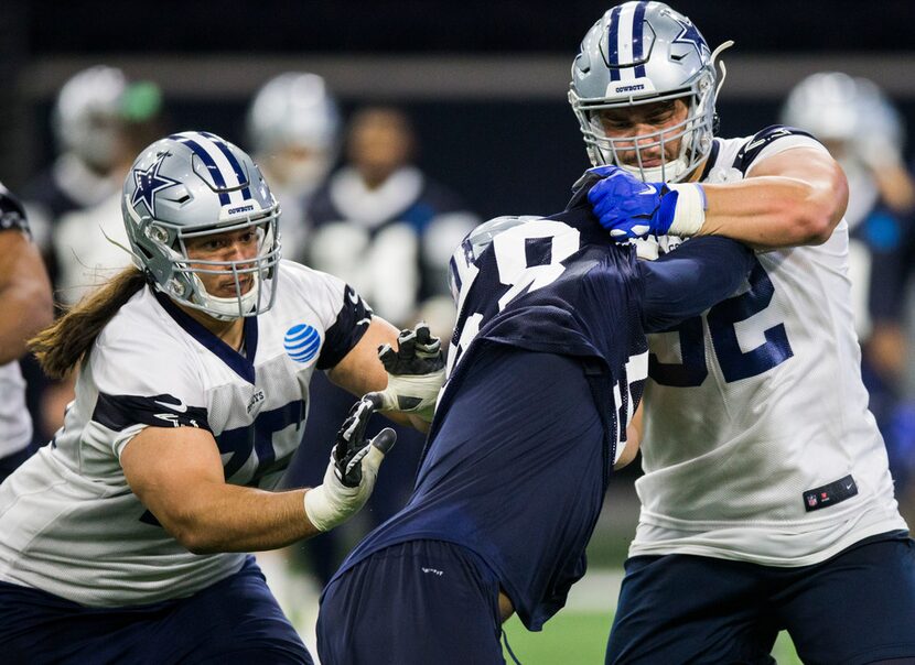 Defensive end Robert Quinn (58) and guard Connor Williams (52, right) collide during a...