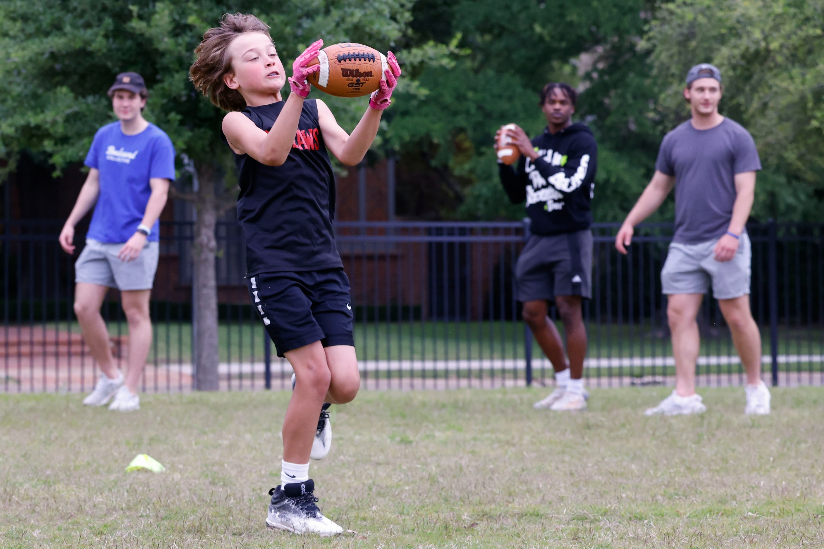 Sam Simons catches the ball during a special session of football drills and practice with...