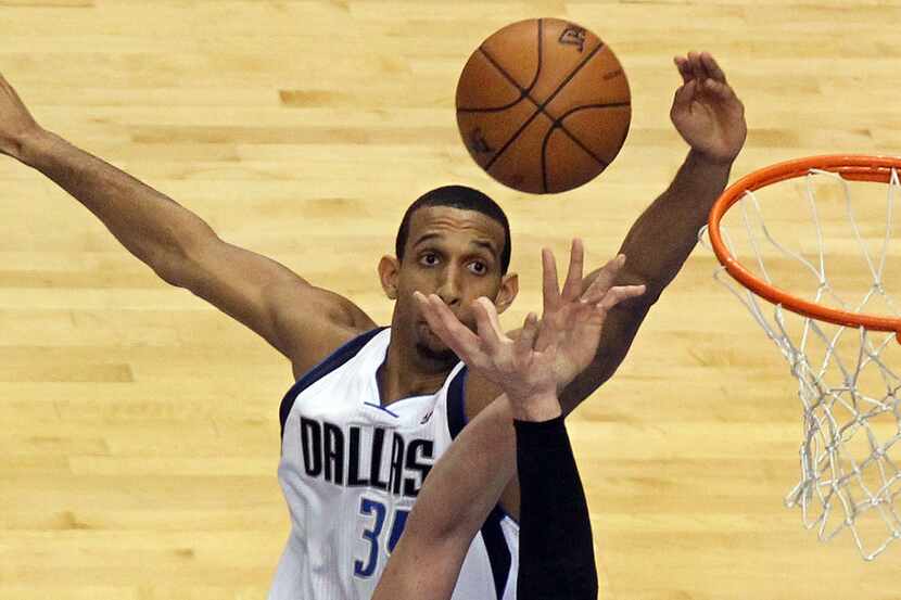 Dallas' Brandan Wright goes high for a rebound in the second quarter during the Houston...