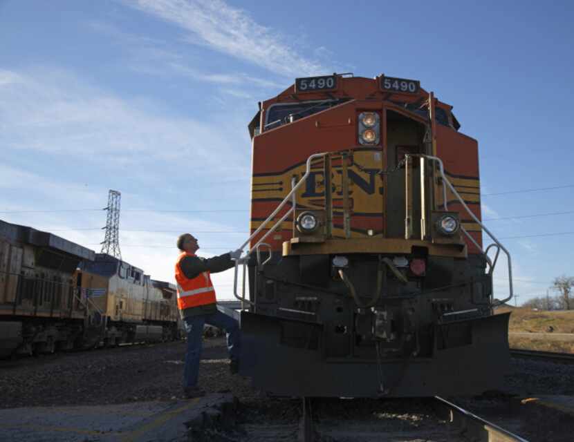 Dallas Morning News clumnist Steve Blow steps on to a BNSF train in Ft. Worth to get...