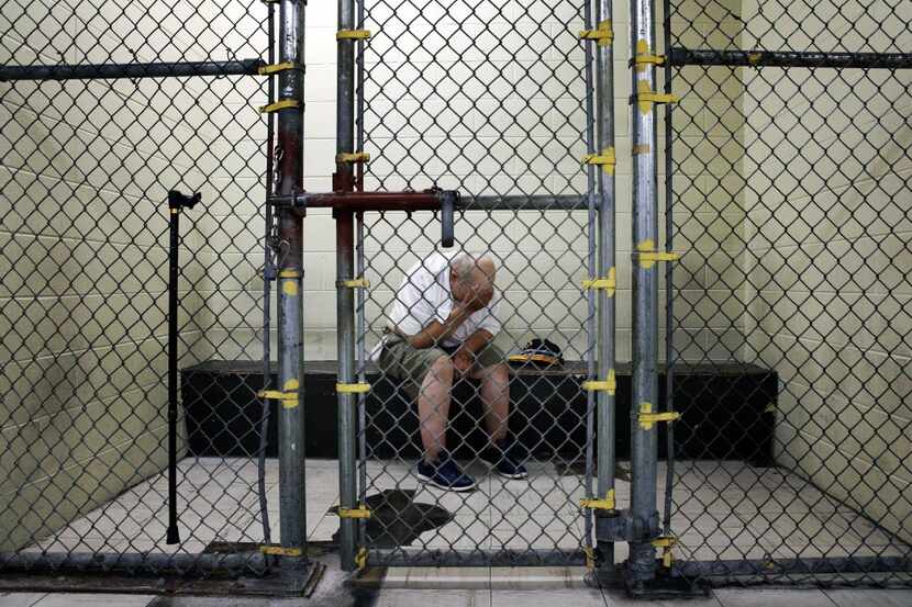 A U.S. veteran with post-traumatic stress sits in a segregated holding pen at the Cook...