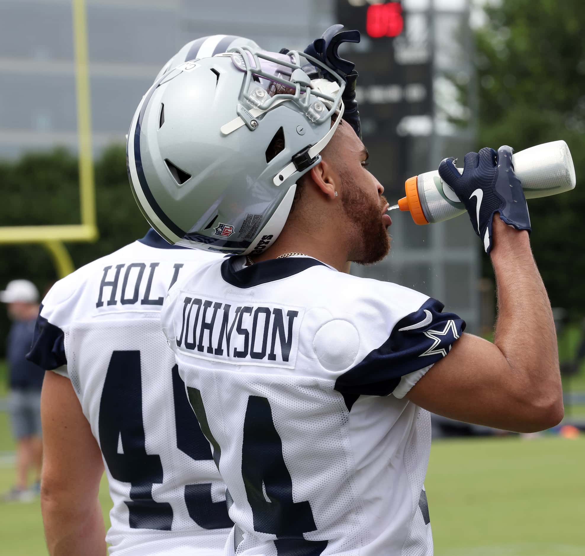Dallas Cowboys receiver Cam Johnson (14) hydrates between drills. The Cowboys' rookie...