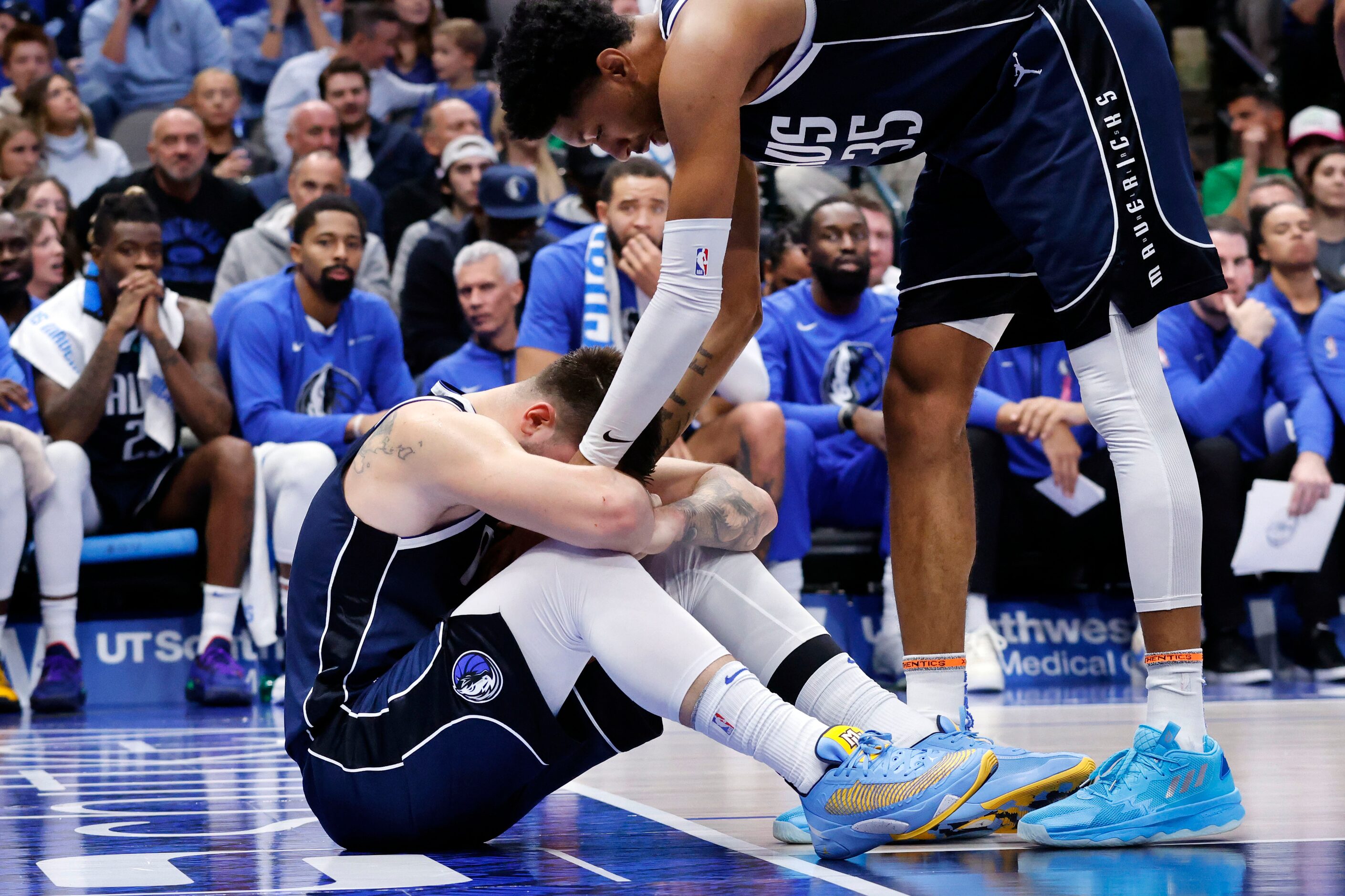 Dallas Mavericks center Christian Wood (35) hands the ball to guard Luka Doncic (77) after...