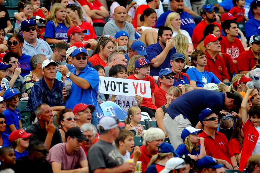 Fans hold up a "Vote Yu" sign to get Yu Darvish into the All Star Game during the Rangers...