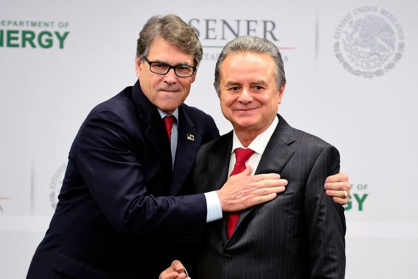 Mexican Energy Minister Pedro Joaquin Codwell (R) jokes with his US counterpart Rick Perry...