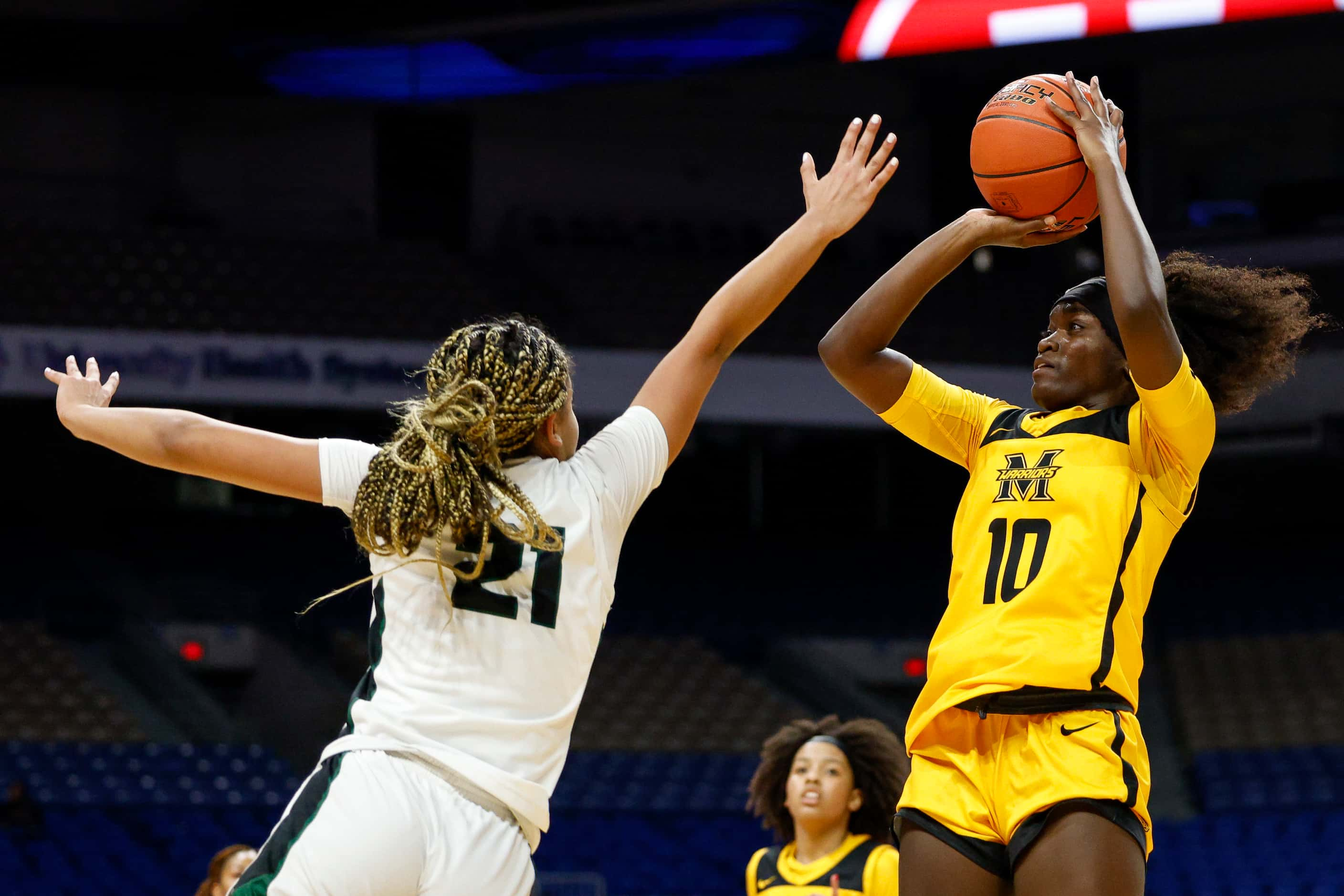 Frisco Memorial guard Jasmyn Lott (10) shoots over Cedar Park guard Gisella Maul (21) during...