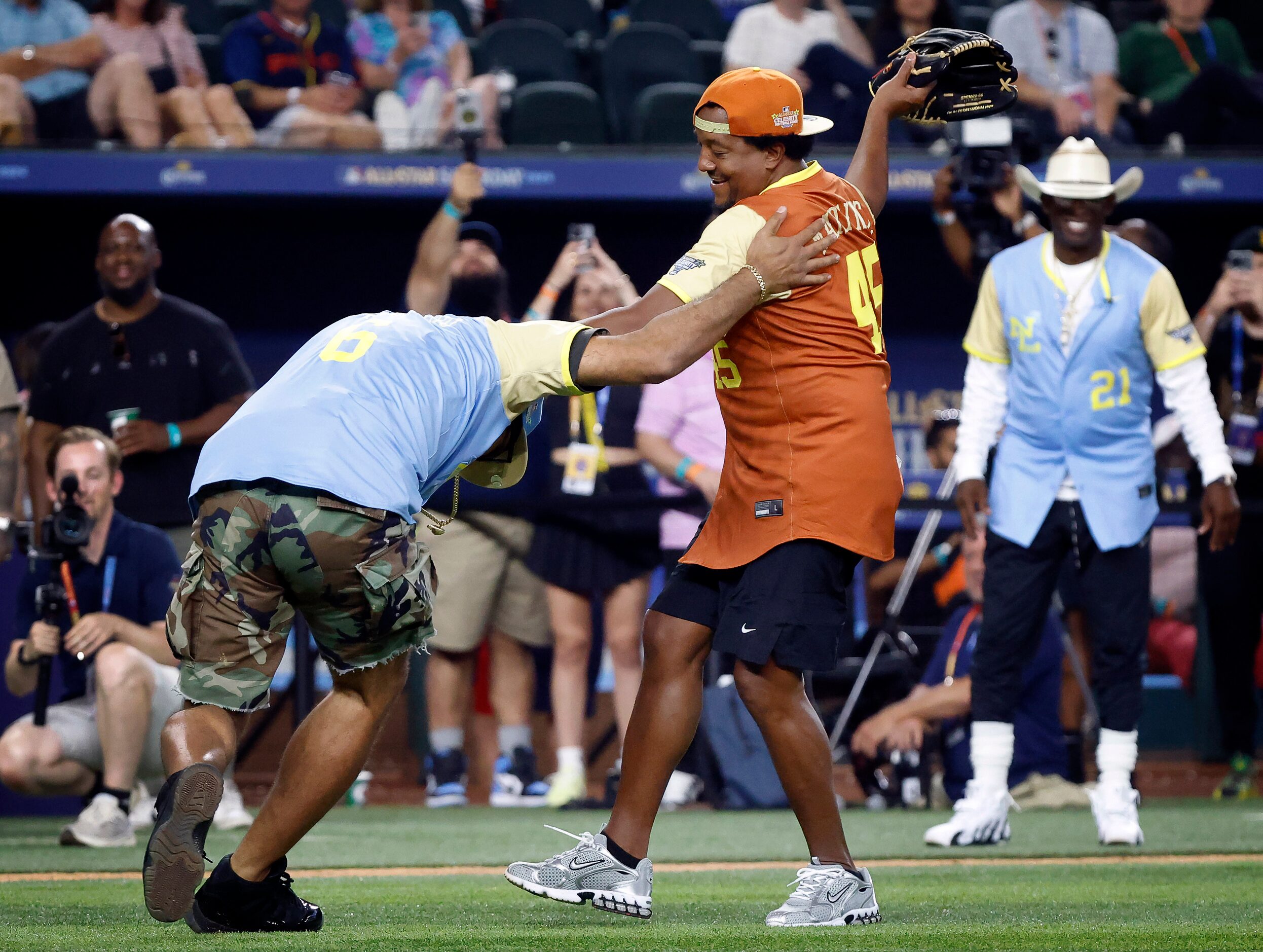 American League pitcher Pedro Martinez (right) swats down National League batter The Kid...