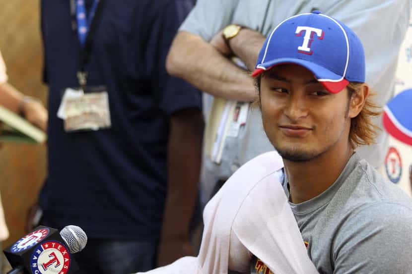 Texas Rangers pticher Yu Darvish, of Japan, talks with reporters after his outing against...