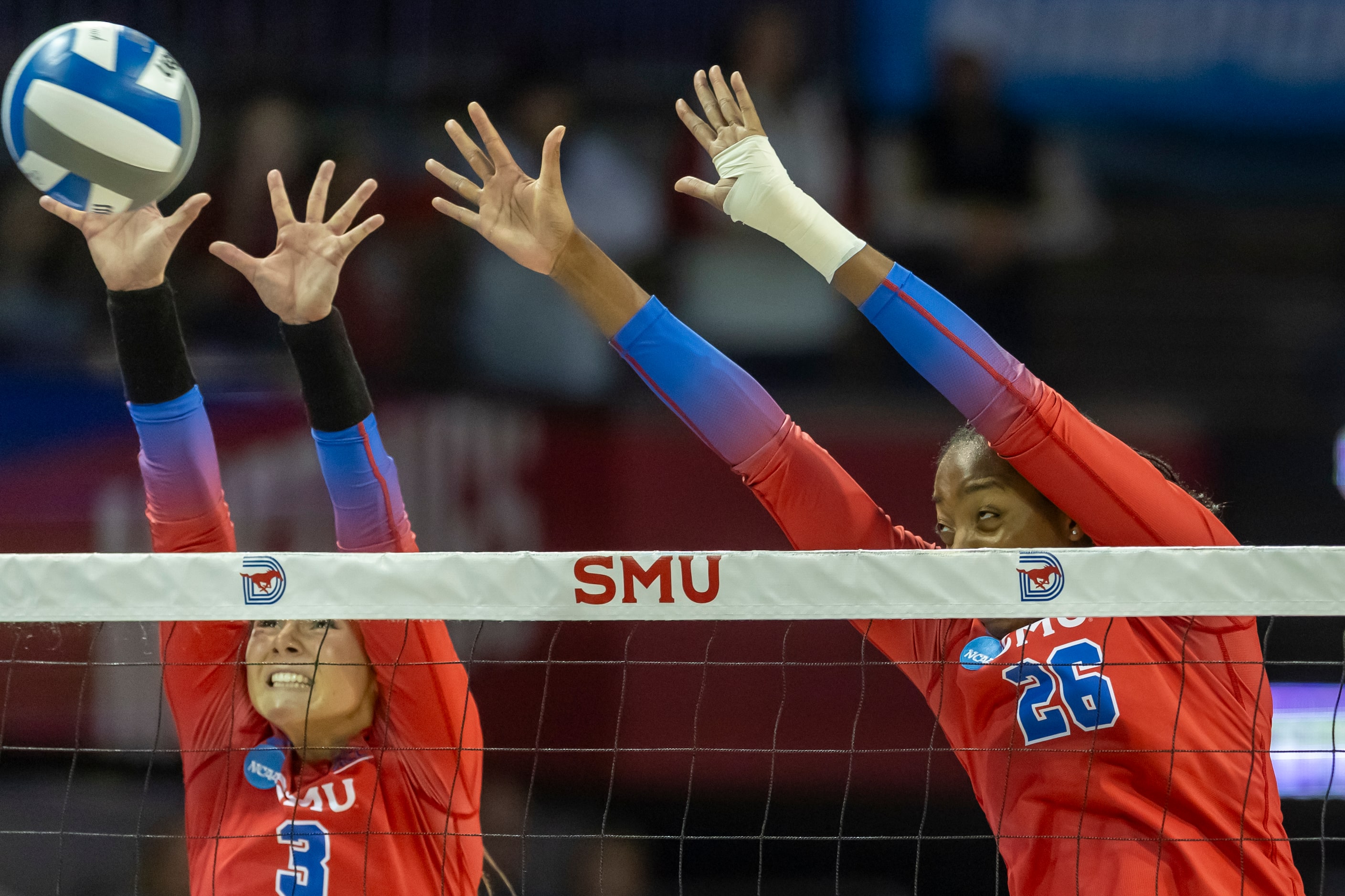 SMU’s Celia Cullen (3) and Nnedi Okammor (26) attempt a block during an NCAA college...