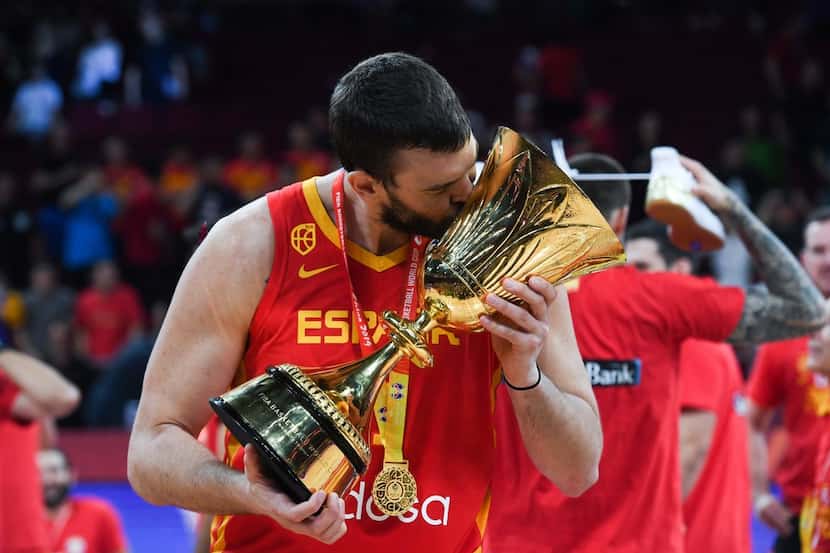 TOPSHOT - Spain's Marc Gasol celebrates with their winning trophy at the end of the...