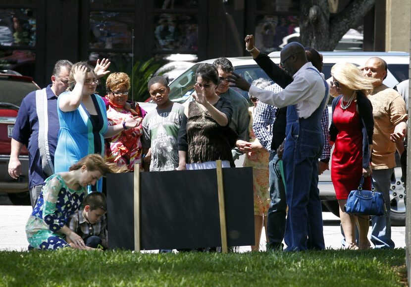 Residents tak part in a prayer walk around the Kaufman County Courthouse in Kaufman, Texas...