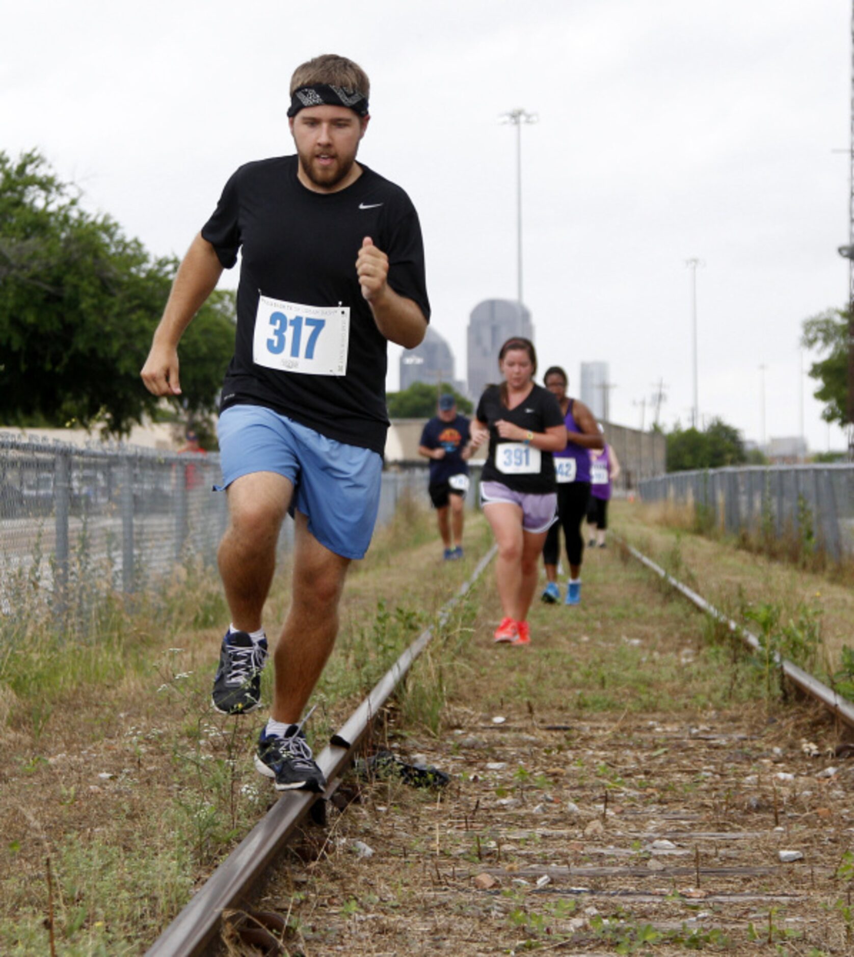 Grant Hagen makes his way down the rail road track during the Second Annual Fair Park 5K...