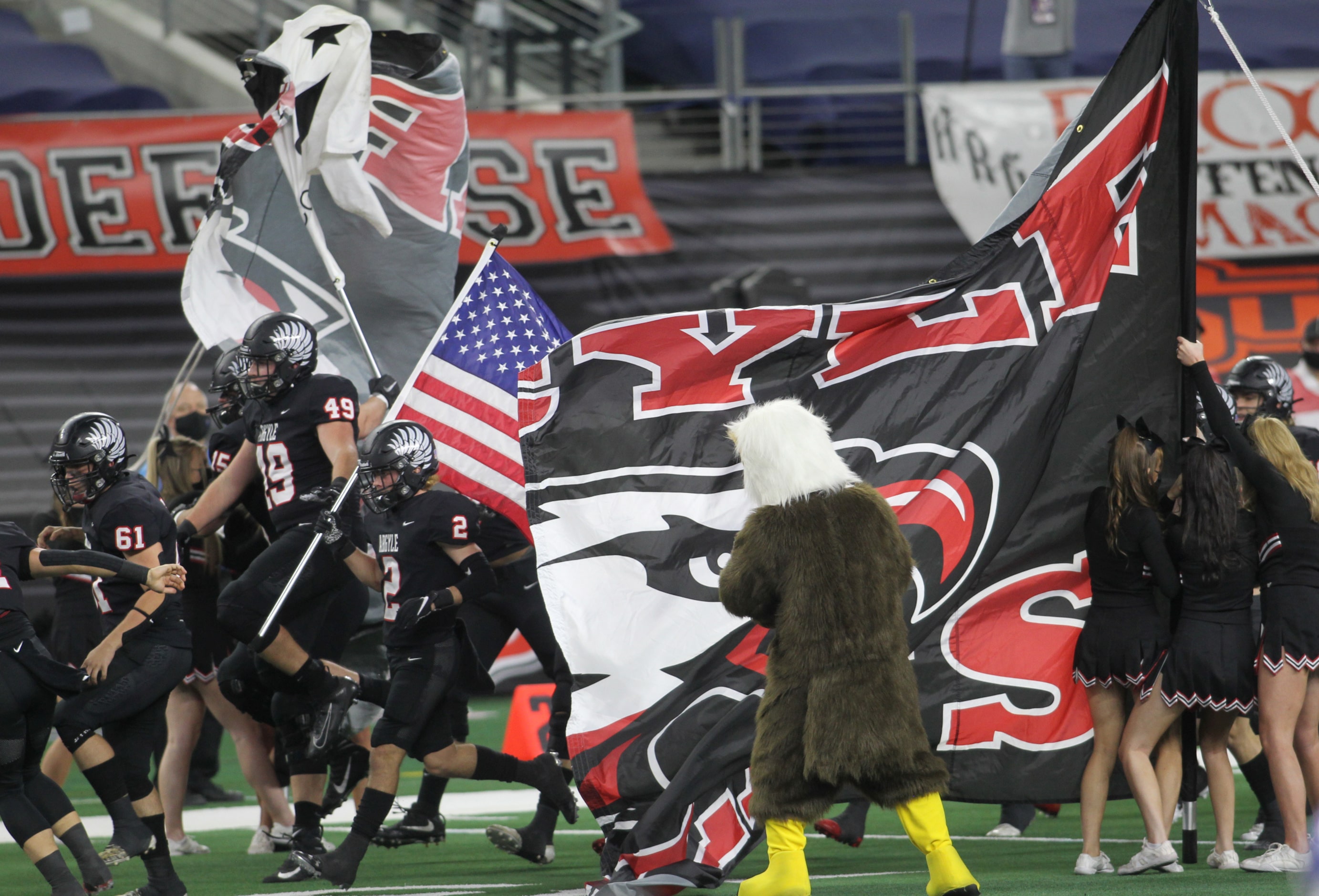 Argyle players bolt onto the field busting through the spirit sign just before the opening...