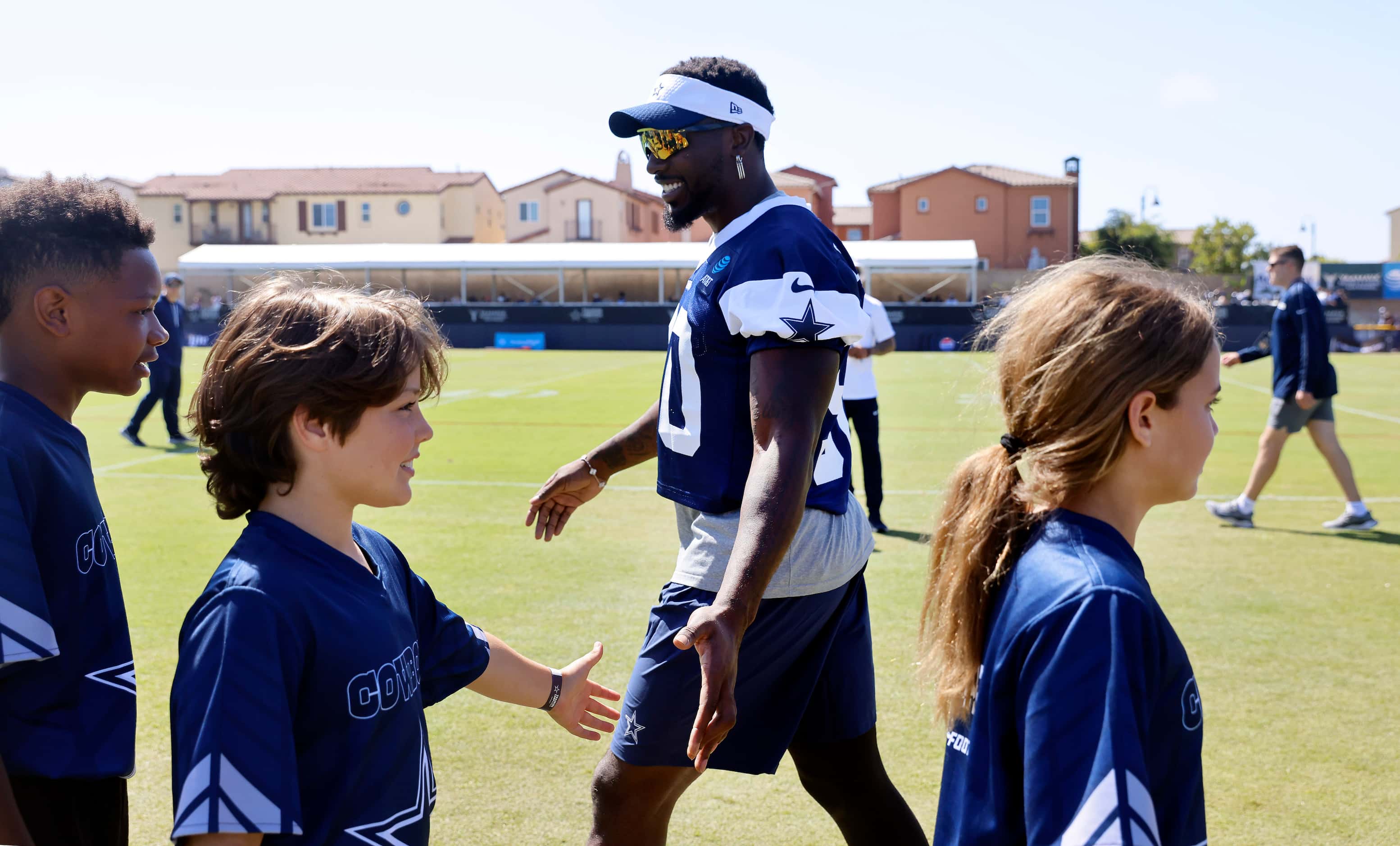 Youth NFL Flag Football players from Ventura County slap hands with Dallas Cowboys players,...