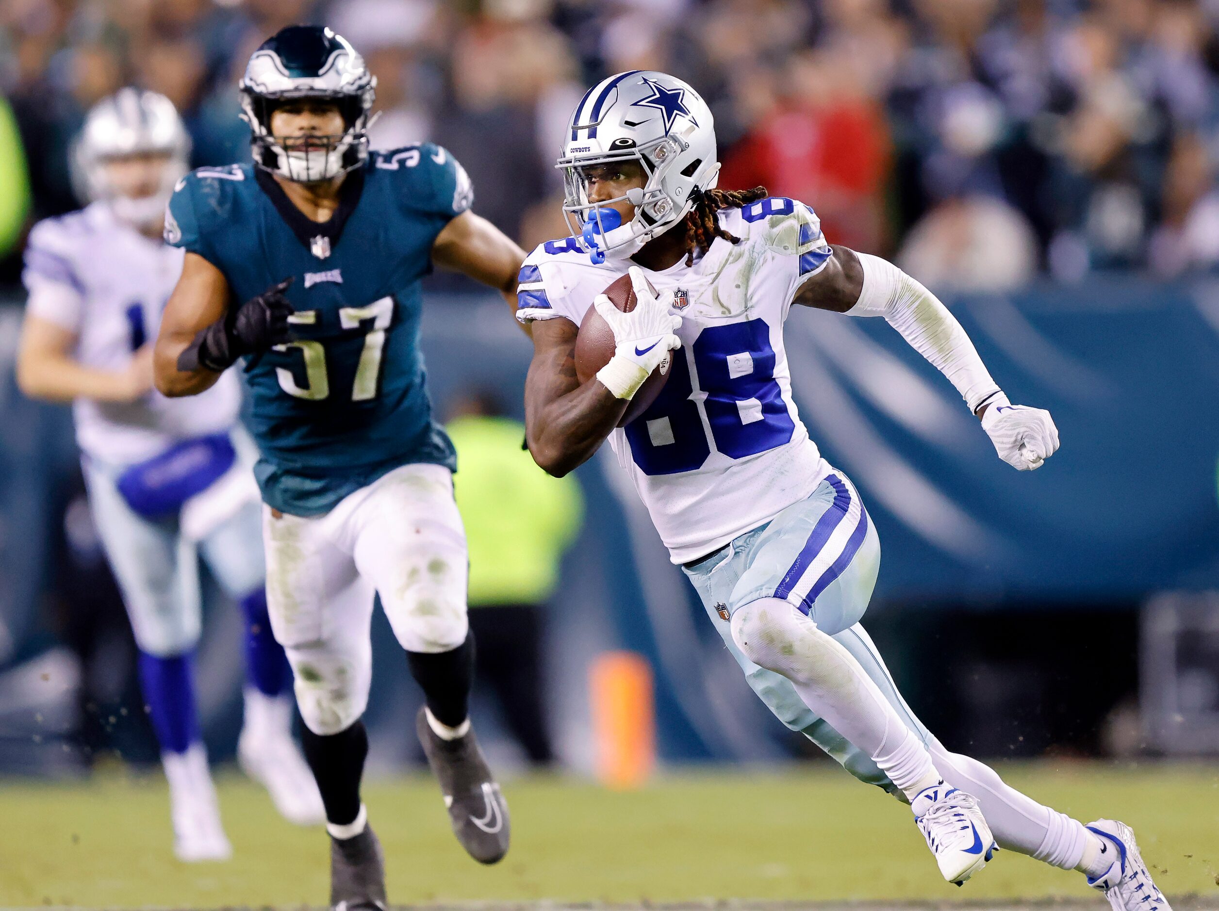 Dallas Cowboys wide receiver CeeDee Lamb (88) runs in open space after catching a fourth...