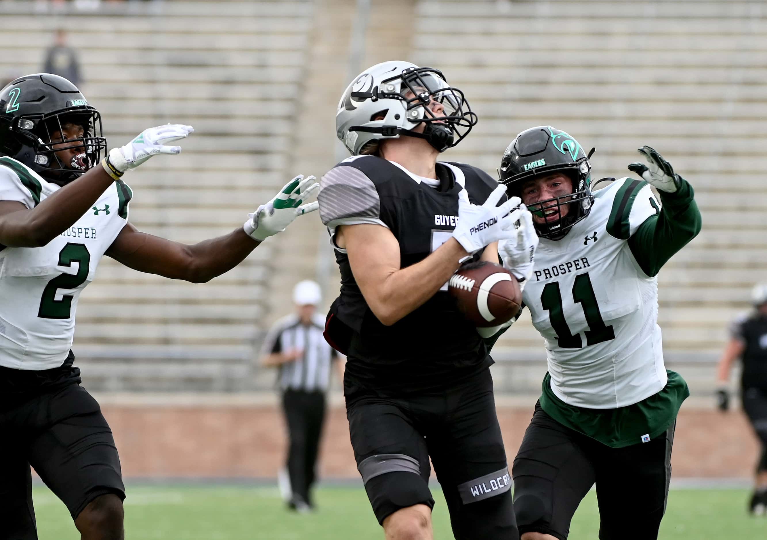 Prosper’s Kaleb Miles (2) and Carson McClendon defend on a pass intended for Denton Guyer's...