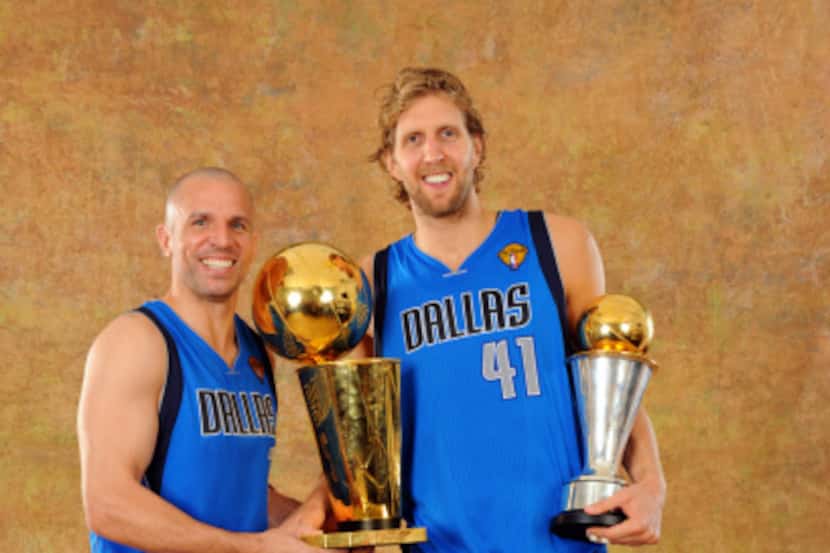Jason Kidd (left) and Dirk Nowitzki pose with the NBA championship trophy. Nowitzki is...