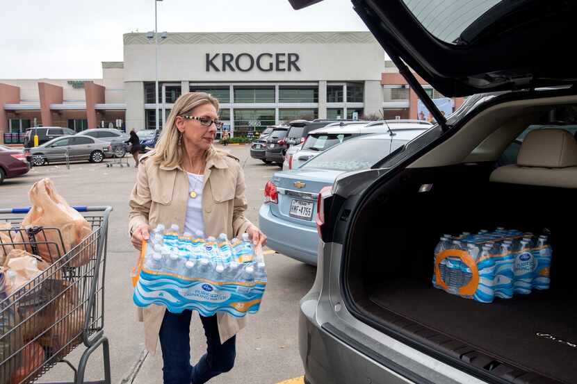Sherri Courie, of Dallas, loaded bottled water into her car outside Kroger at Mockingbird...