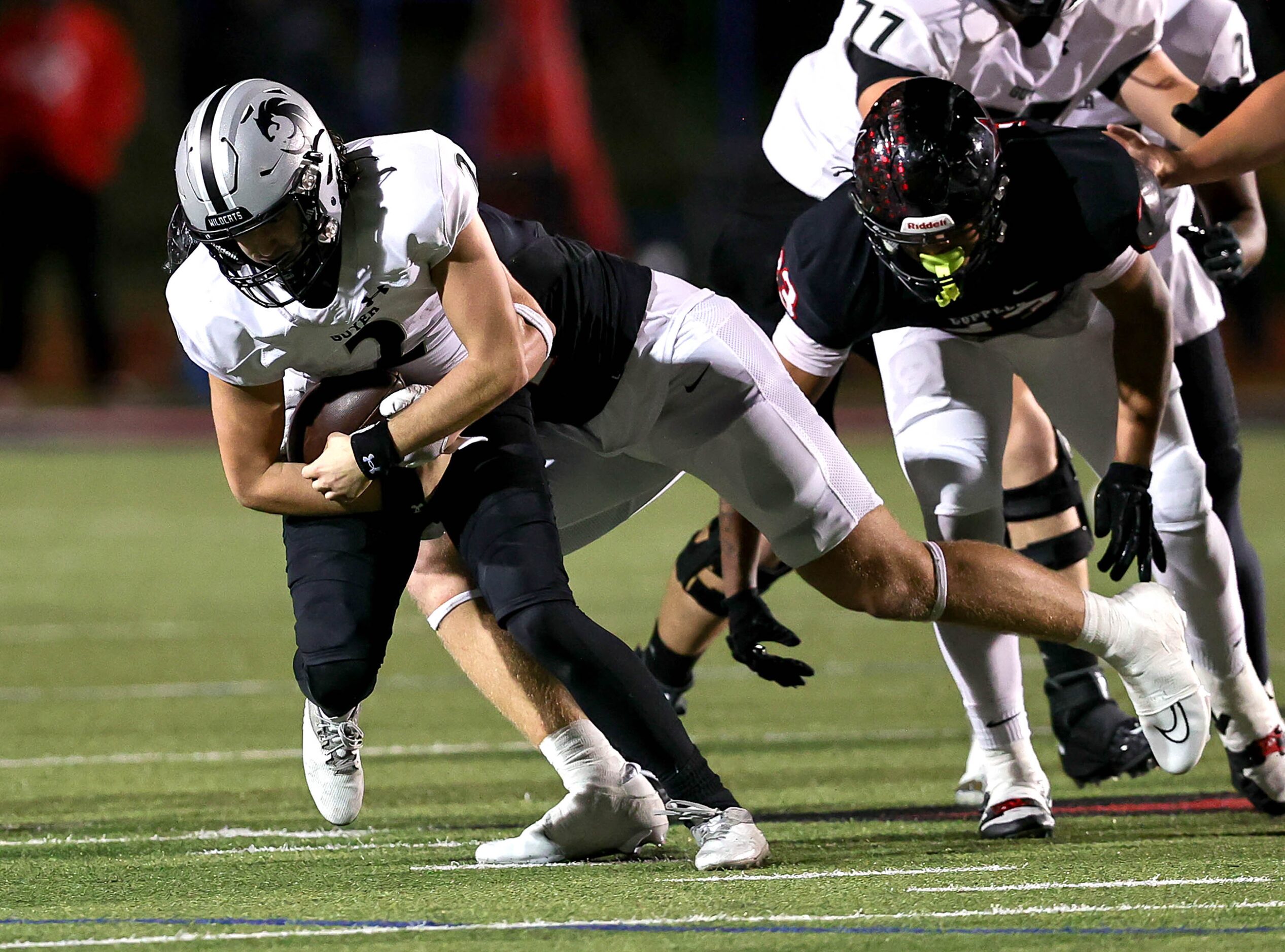 Denton Guyer quarterback Logan McLaughlin (2) gets sacked by Coppell defensive lineman Blake...