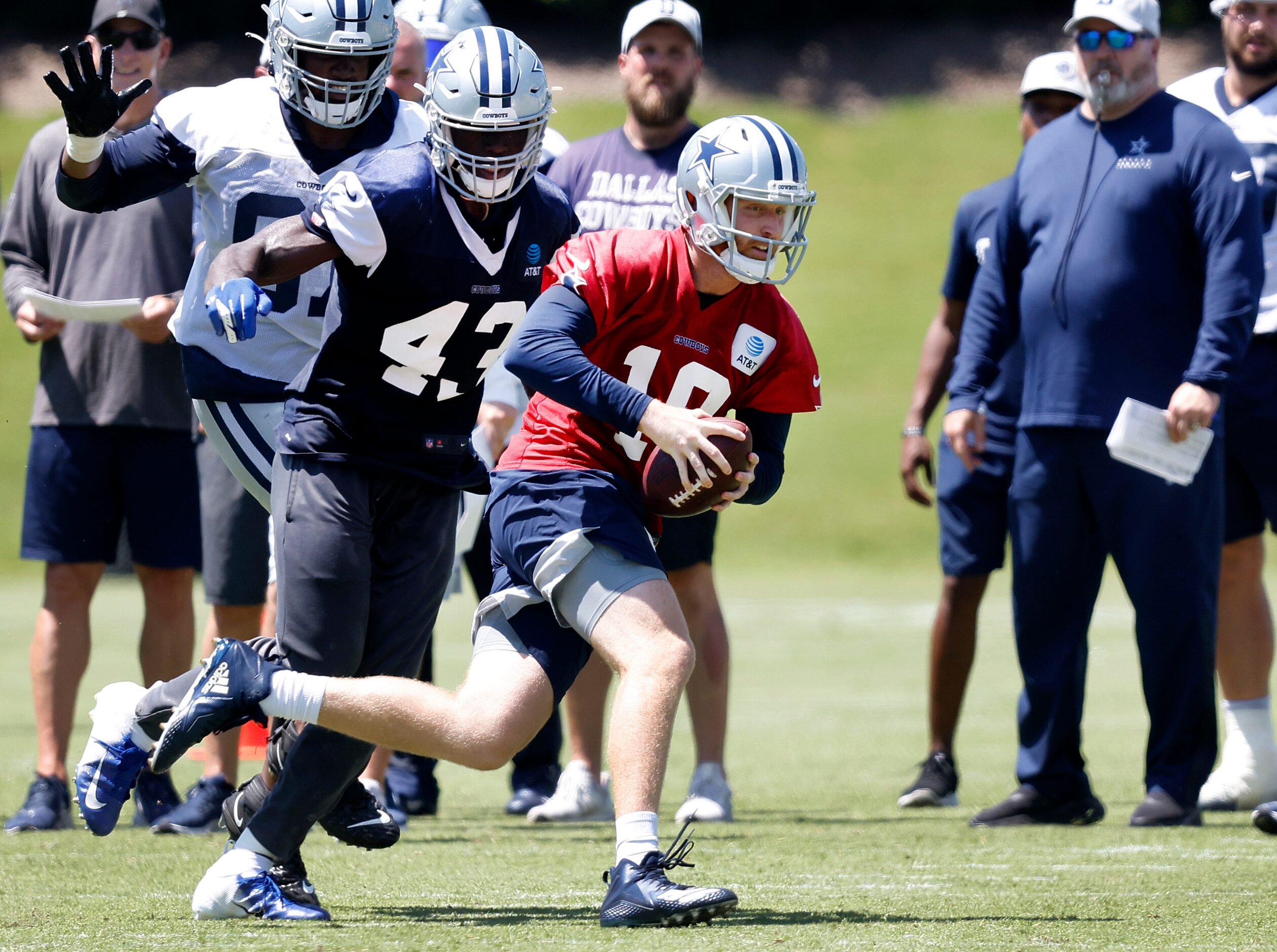 Dallas Cowboys quarterback Cooper Rush (10) races out of the pocket and away from linebacker...