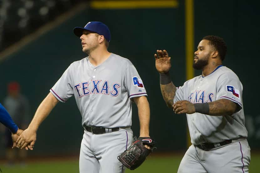 Texas Rangers' Shawn Tolleson, left, and Prince Fielder react after the Rangers defeated the...