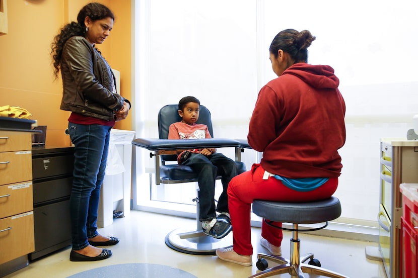 Akshaj Nagilla, 8, of Frisco, prepares to have his blood drawn during a checkup with his...