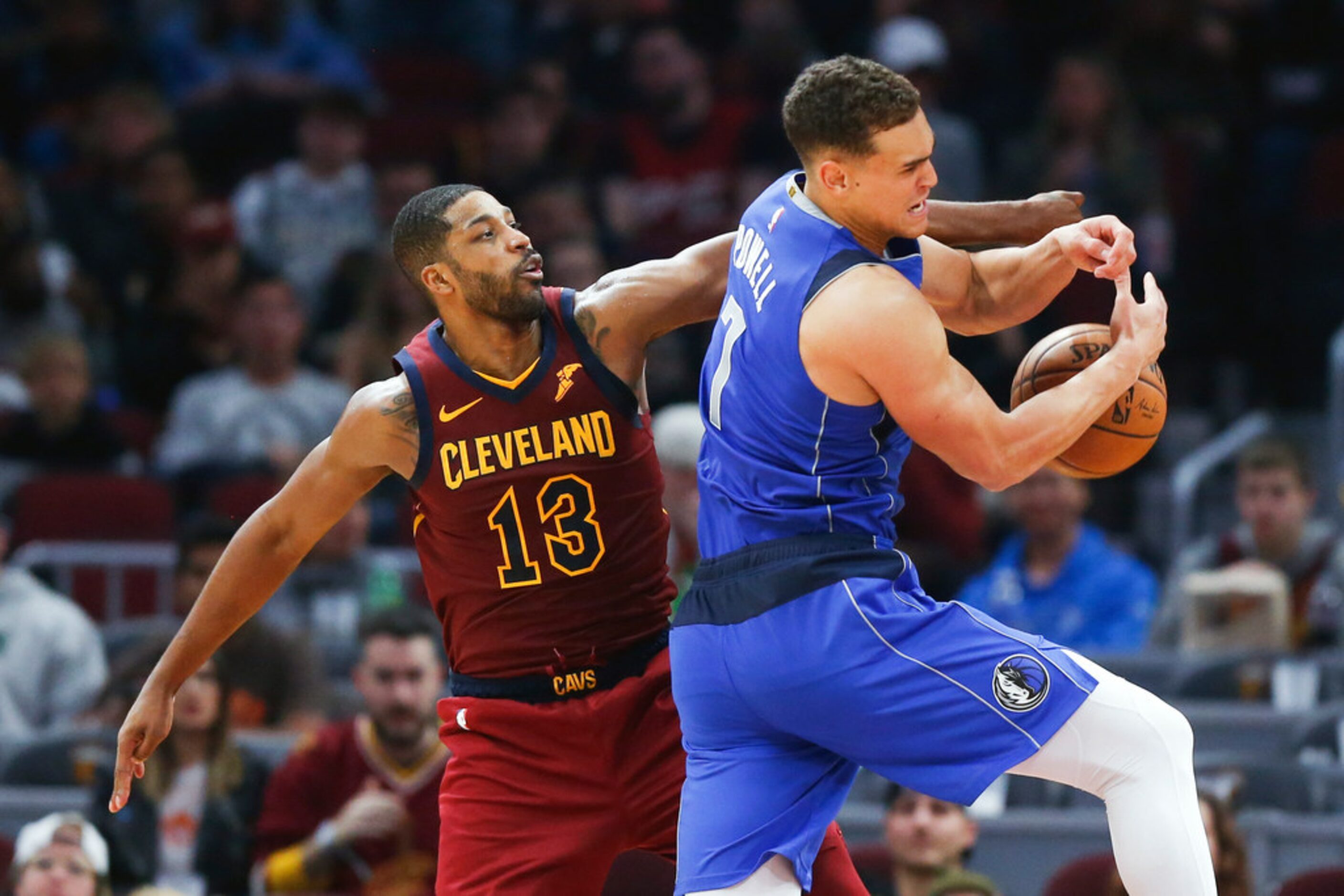 Dallas Mavericks' Dwight Powell (7) battles Cleveland Cavaliers' Tristan Thompson (13) for a...